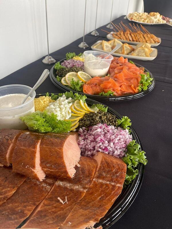 A table of plates set out for an event catered by Alley Cat Oyster Bar