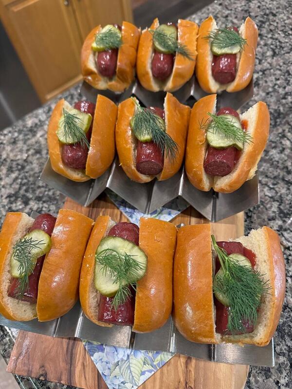 Hot dogs with pickles and dill catered by Alley Cat Oyster Bar