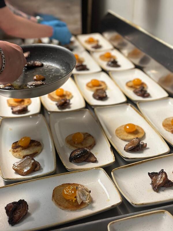 A chef preparing plates for a private event